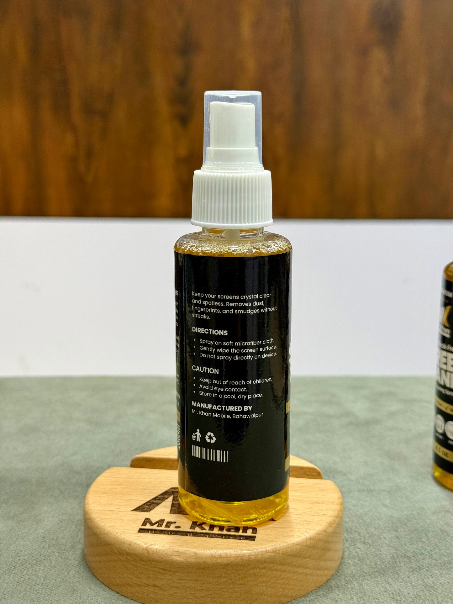 Bottle of Mr. Knan product on a wooden stand with a blurred background