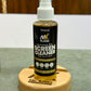 Bottle of screen cleaner on a wooden stand with a blurred background